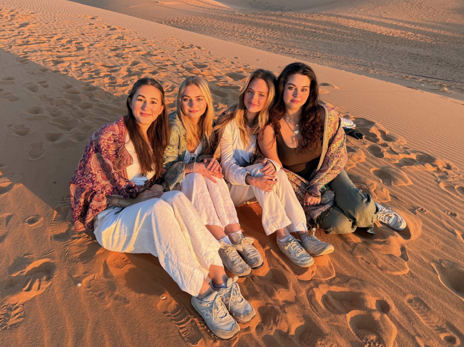 Brooke and friends on sand dunes at sunset
